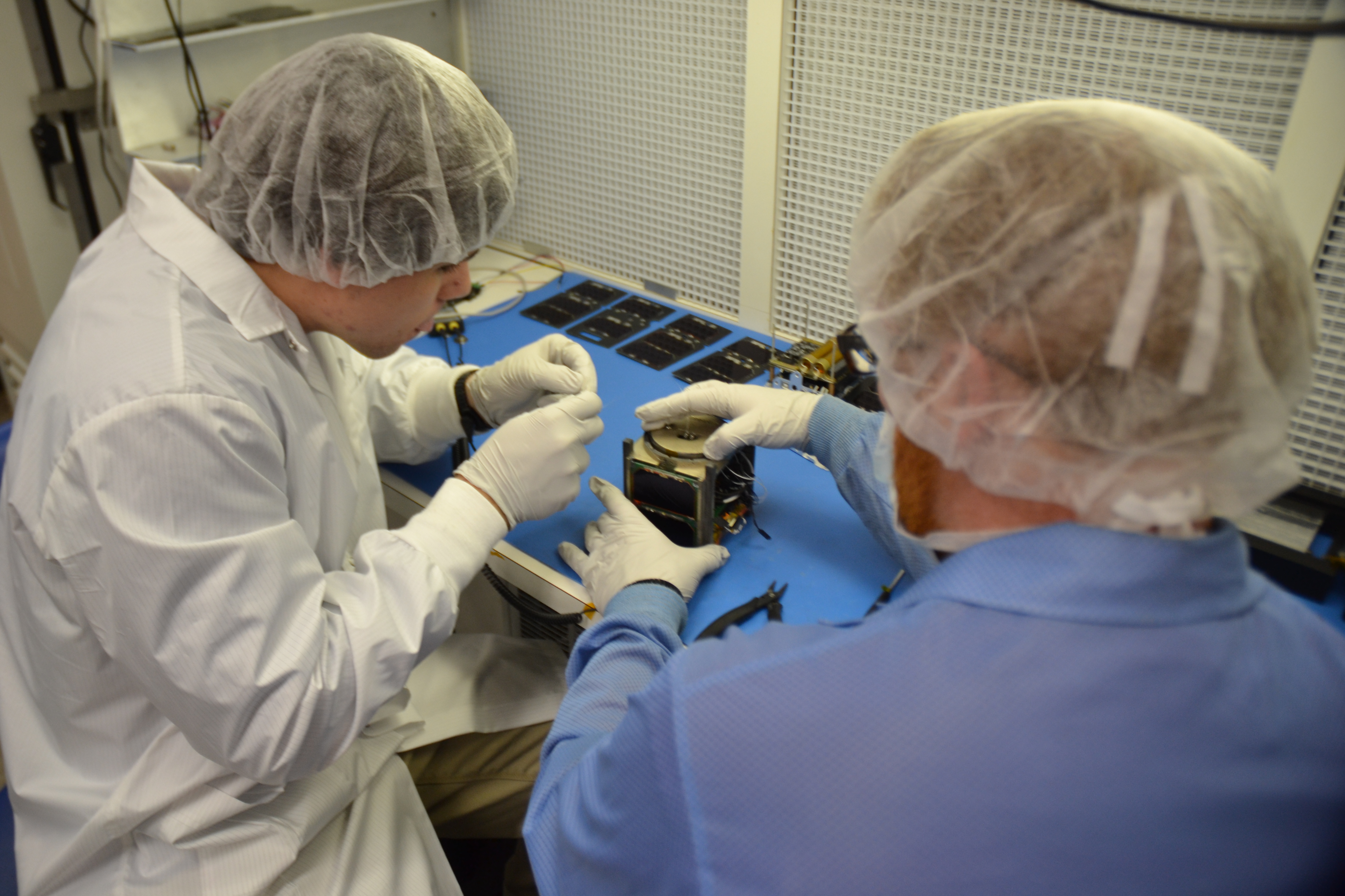 Students assembling a CubeSat